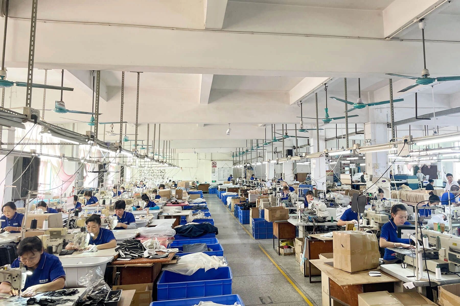 Production floor at Ecoicolortote Dongguan facility with workers at sewing stations